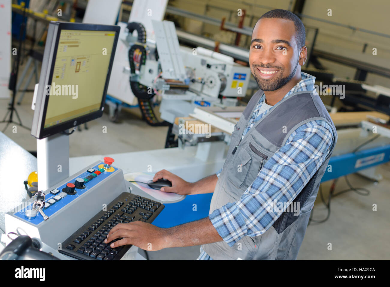 Man typing at factory computer Stock Photo - Alamy