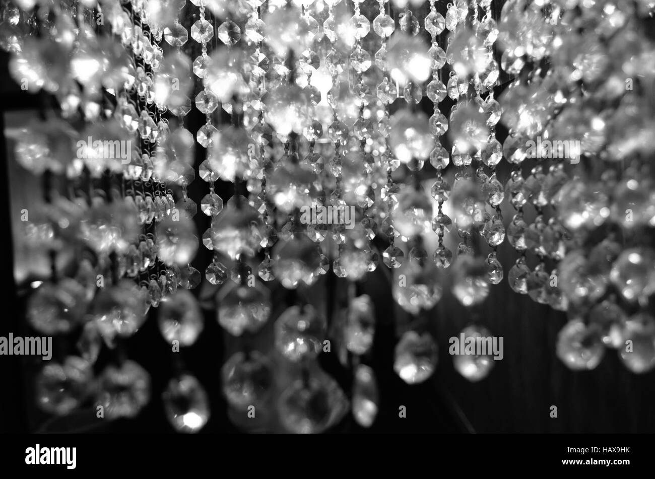 orange pendant lamp with small glass diamonds on a dark blurred background Stock Photo
