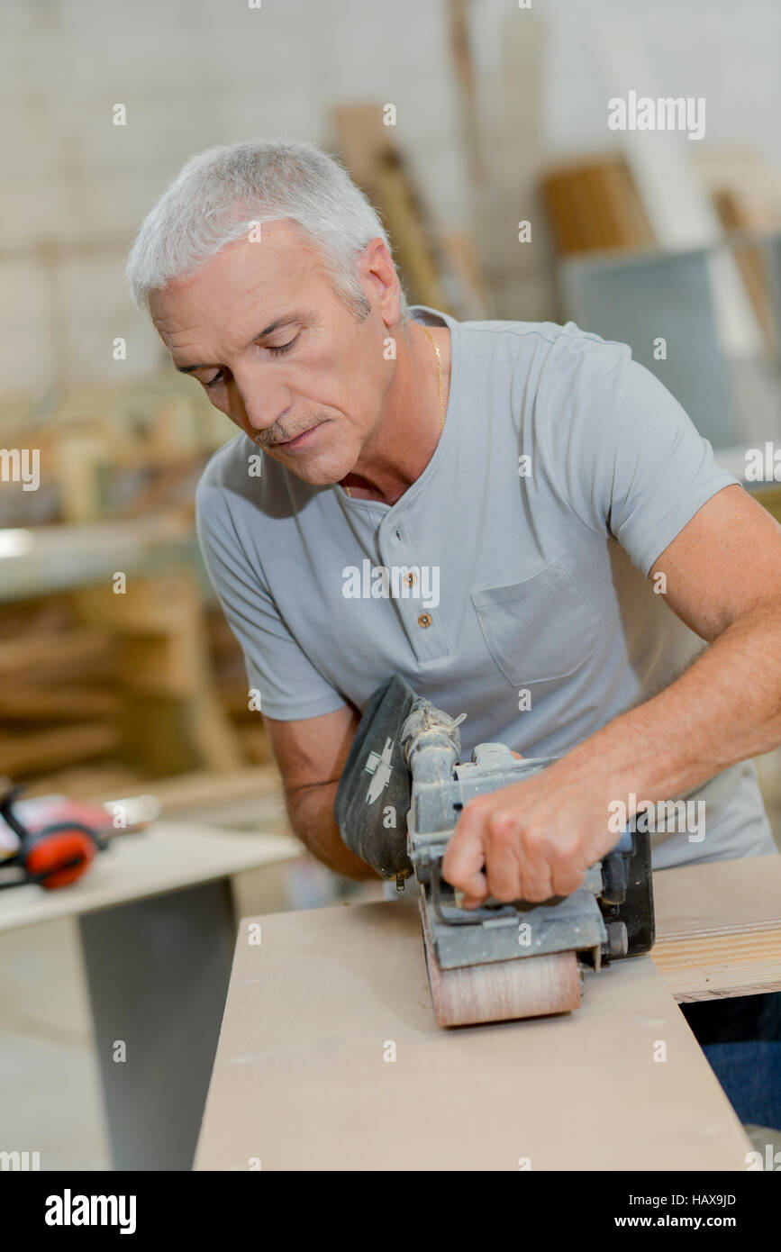 Carpenter using a belt sander Stock Photo Alamy