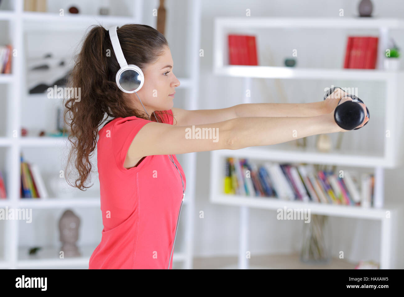 young fitness woman in gym and listen music with headset Stock Photo