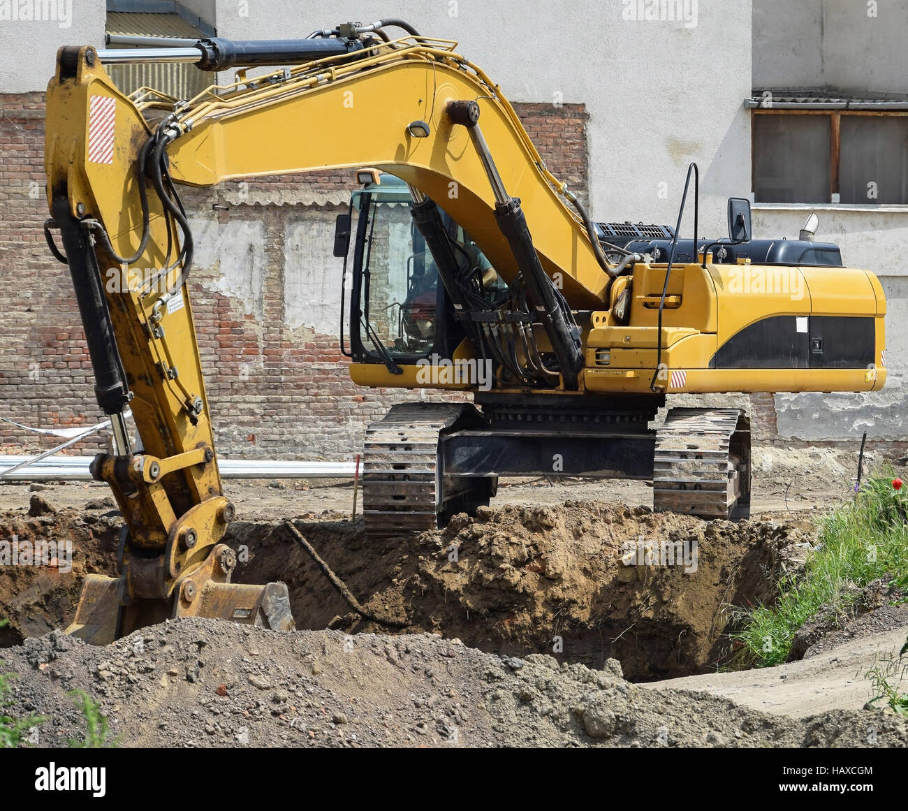 Excavator works at the road construction Stock Photo Alamy