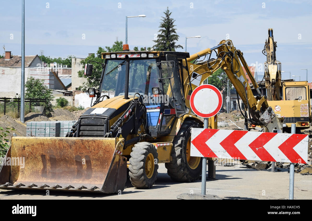 Excavator works at the road construction Stock Photo