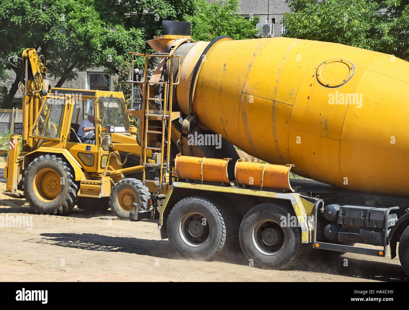 Cement mixer and excavator Stock Photo Alamy