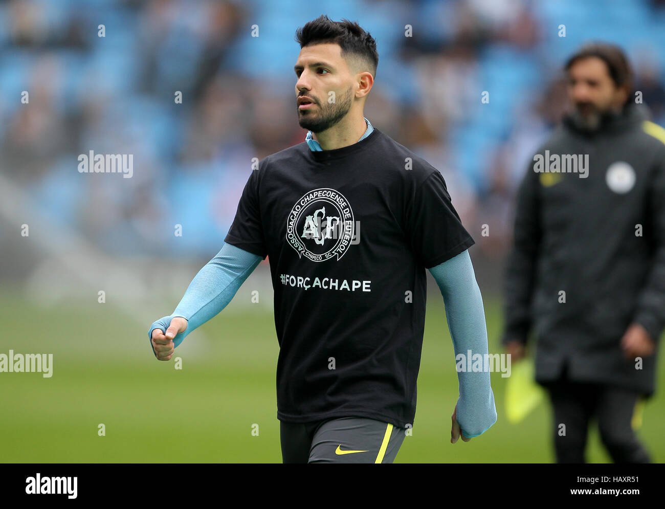Manchester City's Sergio Aguero warms up in a t-shirt remembering Brazil football team Chapecoense who were involved in the columbia plane crash prior to the Premier League match at the Etihad Stadium, Manchester. Stock Photo