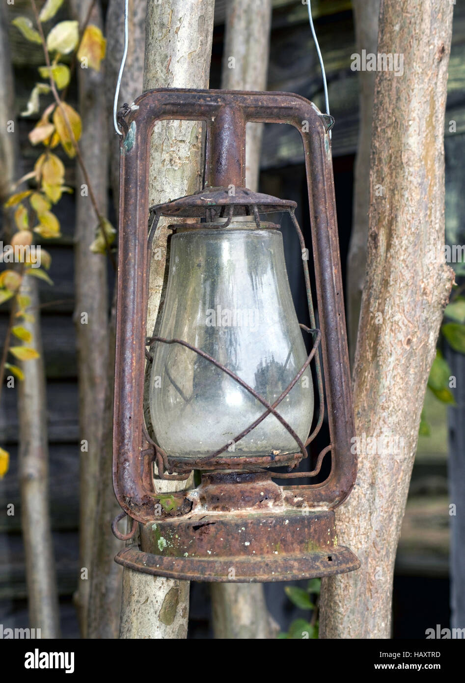 Old rusty gold antique coal oil lantern. Stock Photo