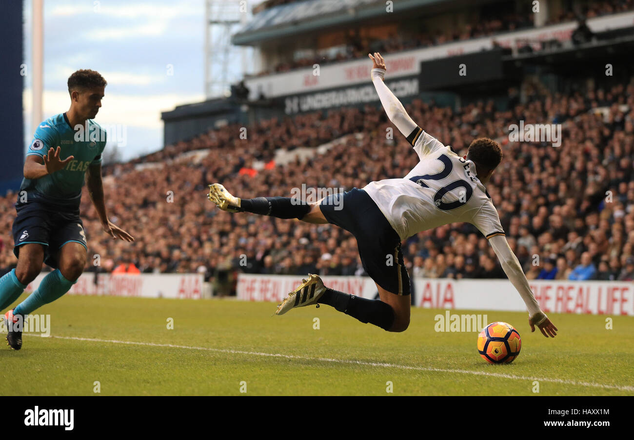 Tottenham Hotspur's Dele Alli (right) goes down in the penalty area after a foul from Swansea City's Kyle Naughton (left) during the Premier League match at White Hart Lane, London. Stock Photo