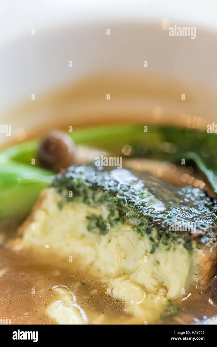 baked homemade tofu with kale and mushroom in gravy sauce Stock Photo