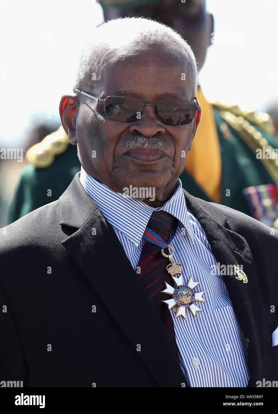 Governor General Elliott Belgrave stands as Prince Harry prepares to leave Grantley Adams International Airport in Barbados as he heads to Guyana, as part of his tour of the Caribbean. Stock Photo