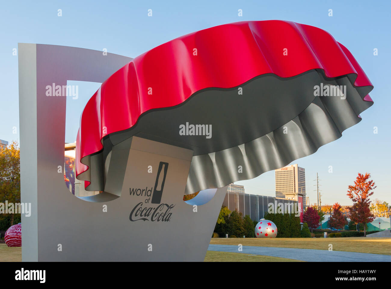 World of Coca-Cola bottle cap information booth in downtown Atlanta with Coca-Cola world headquarters building in background. Stock Photo