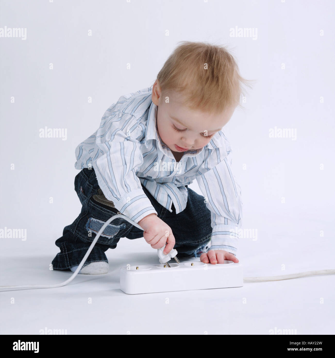 little boy plays with plug Stock Photo Alamy