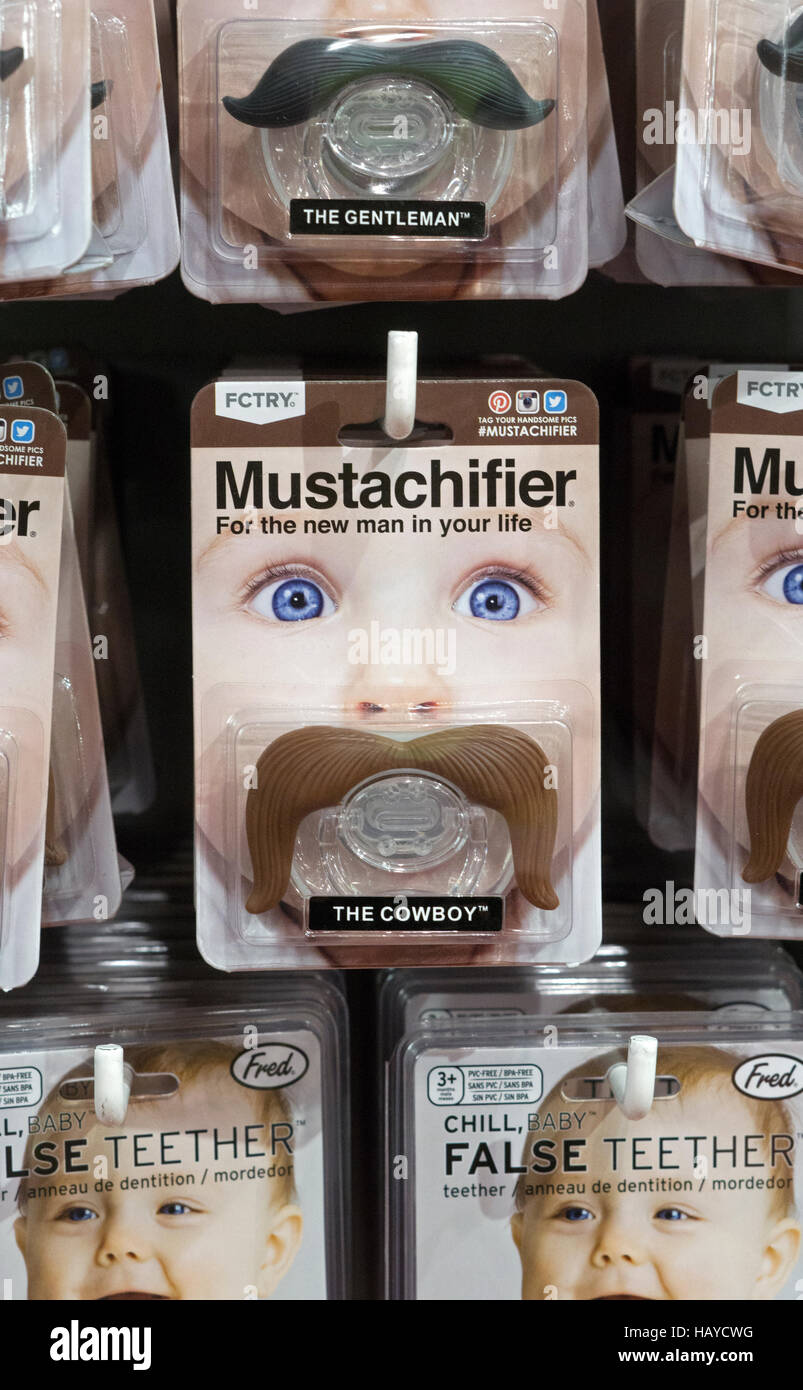 Gag gift on a bay's pacifier with a fake mustache at It'sugar on Broadway in Greenwich Village New York City. Stock Photo