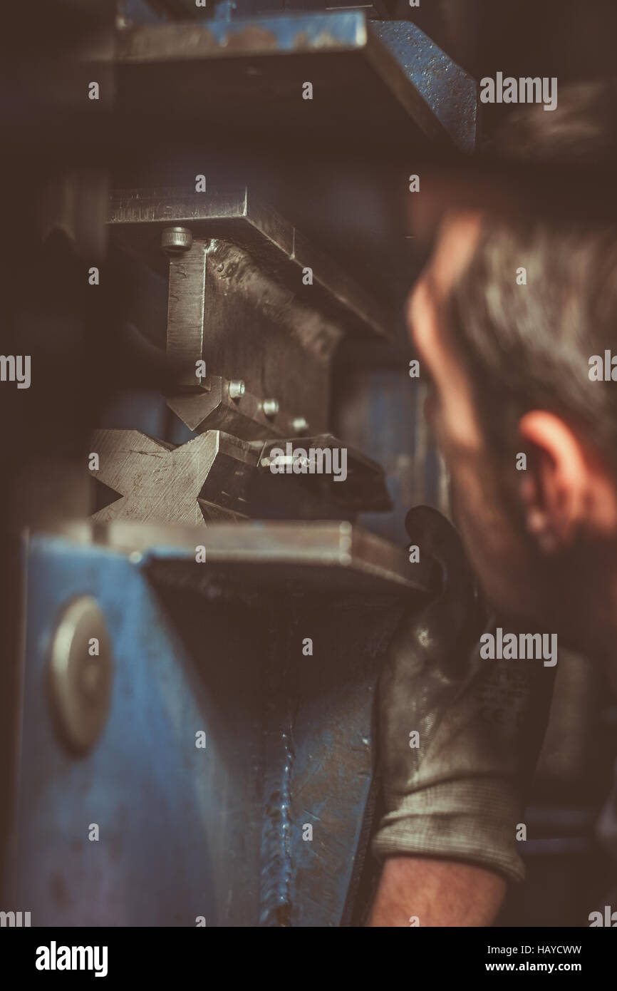 Worker bending a sheet of metal with an industrial equipment Stock ...