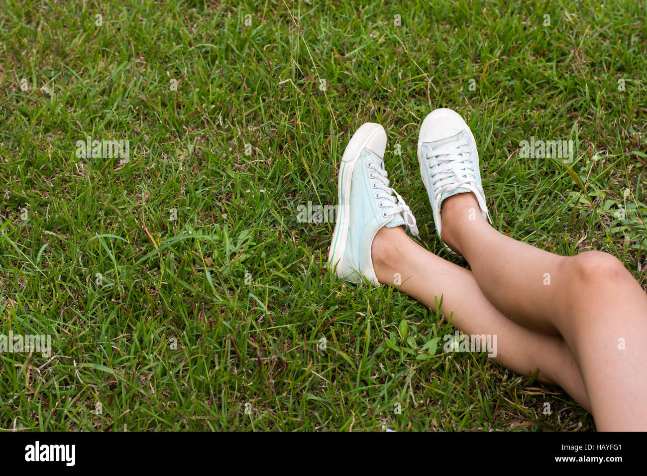 Woman feet on grass Stock Photo - Alamy