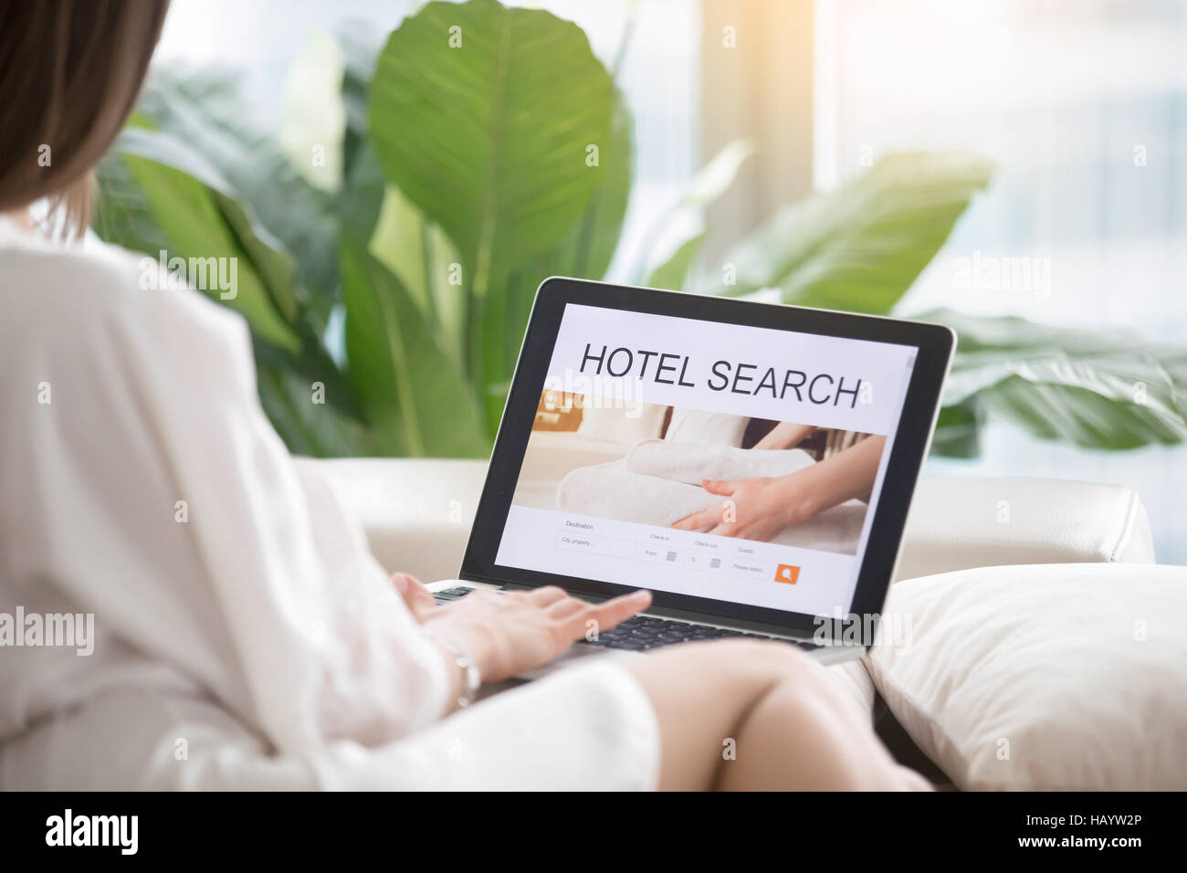 Young woman searching a hotel online Stock Photo