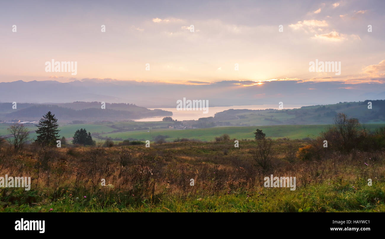 Slovakia autumn sunny morning panorama. Rural fall mountain scene. Village in valley. Stock Photo