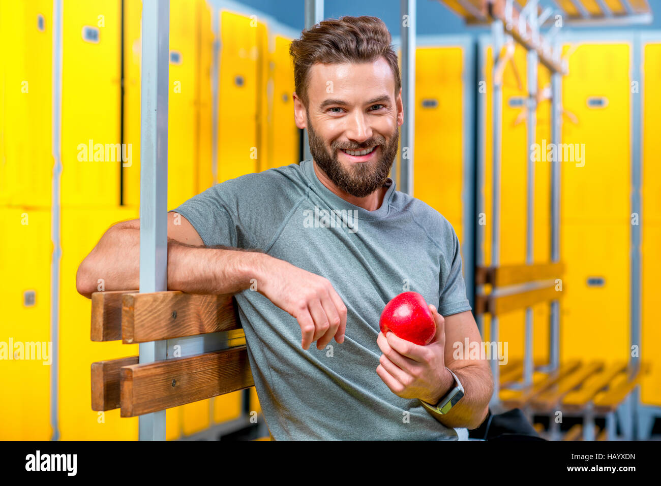Man with apple in the gym Stock Photo