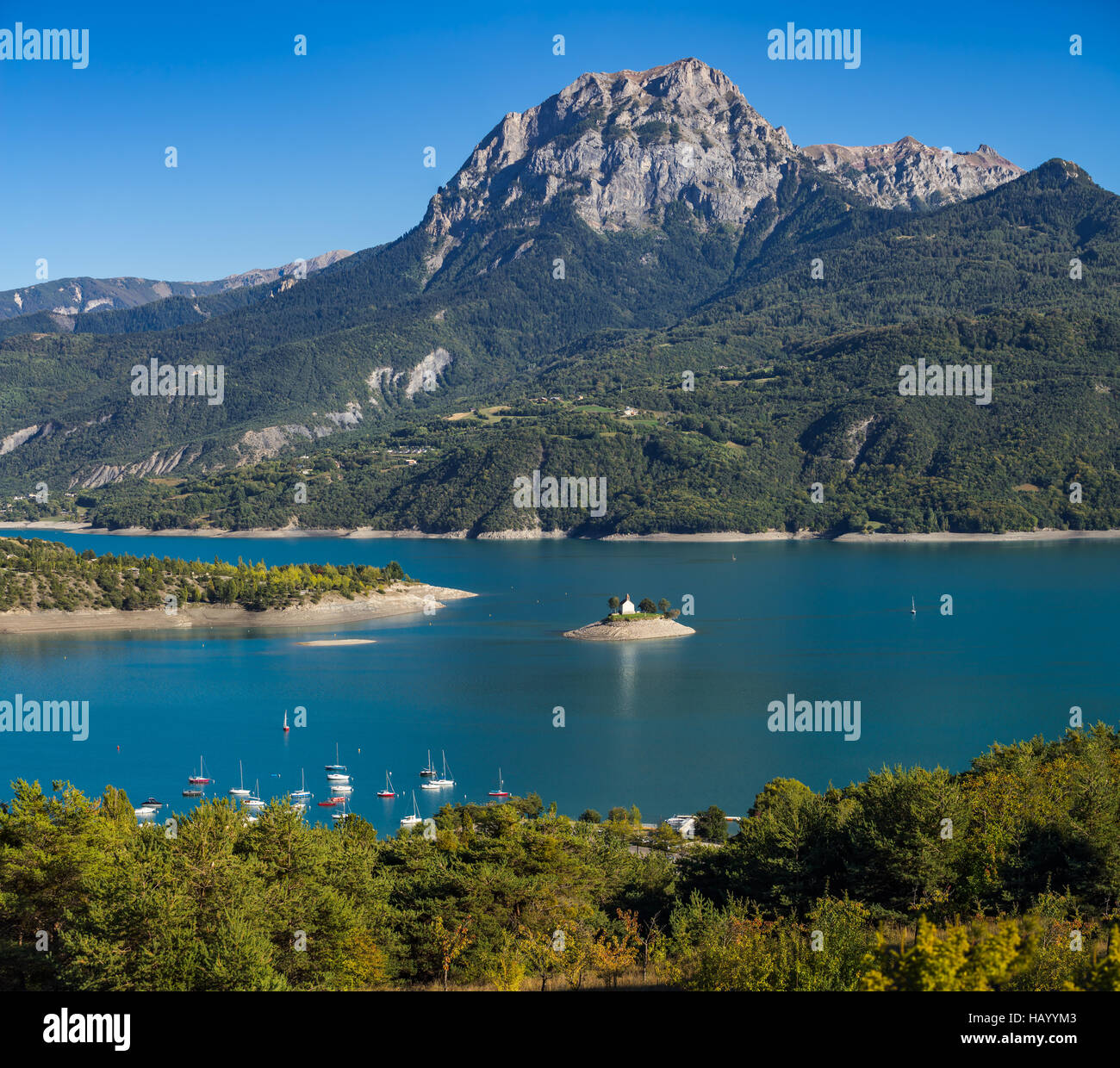 View of the Grand Morgon peak on Summer afternoon. The Saint Michel Bay (with the Chapel) and Serre Poncon Lake. France Stock Photo