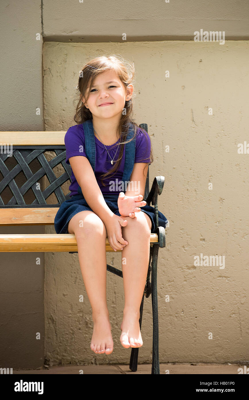 Little girl sitting legs crossed hires stock photography and images