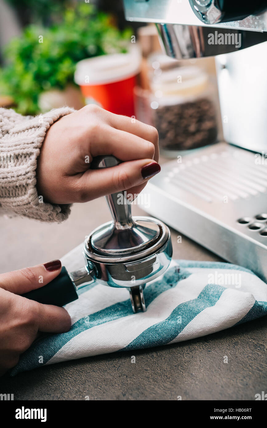 Female tamping fresh coffee for espresso Stock Photo Alamy