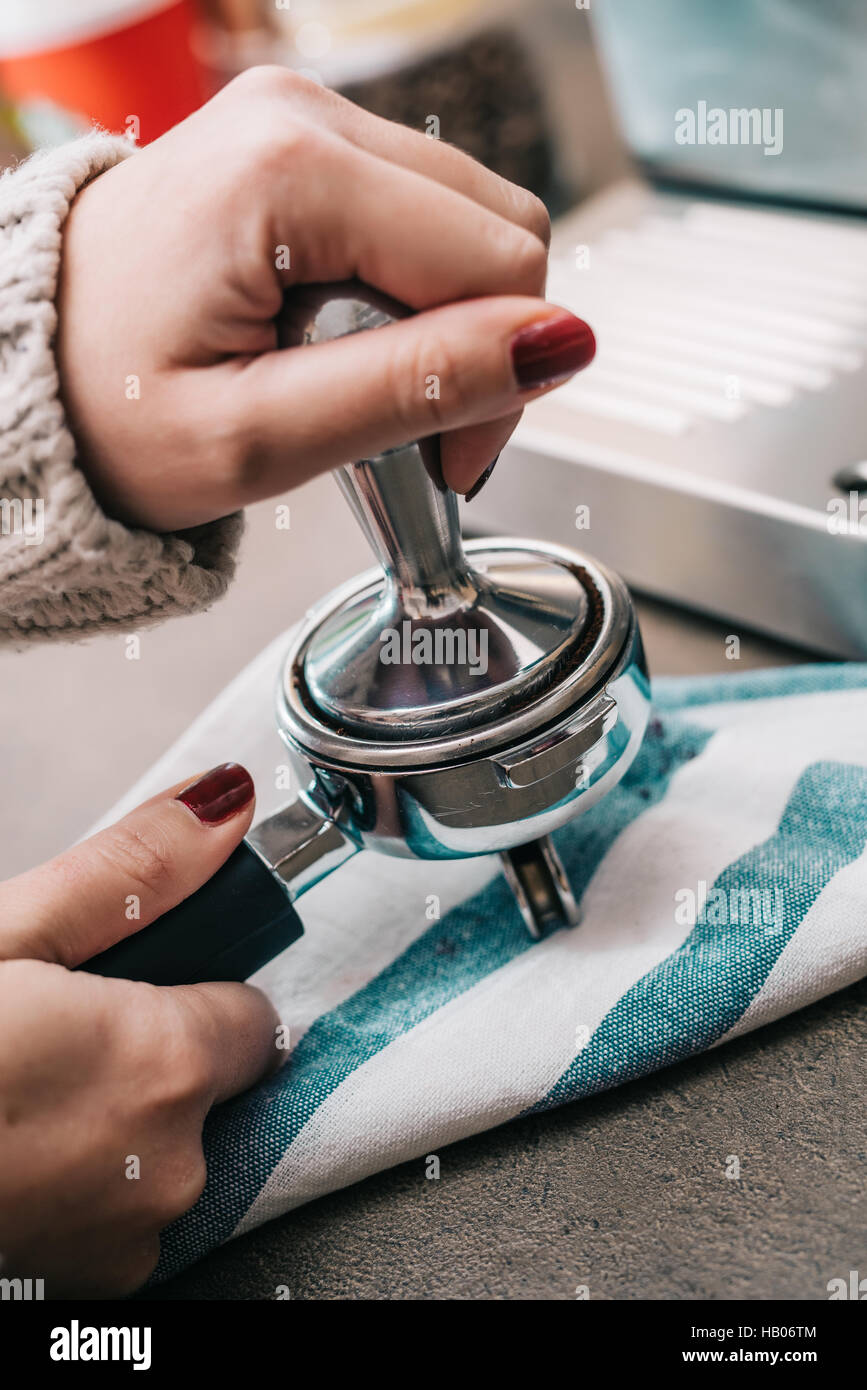 Female tamping fresh coffee for espresso Stock Photo Alamy