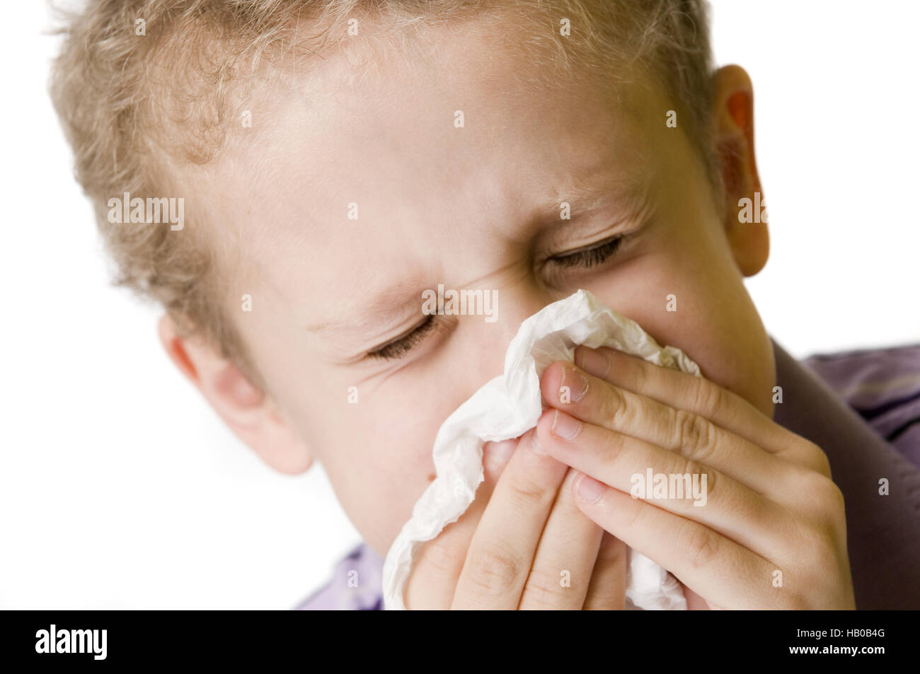 boy blow nose closed eyes Stock Photo