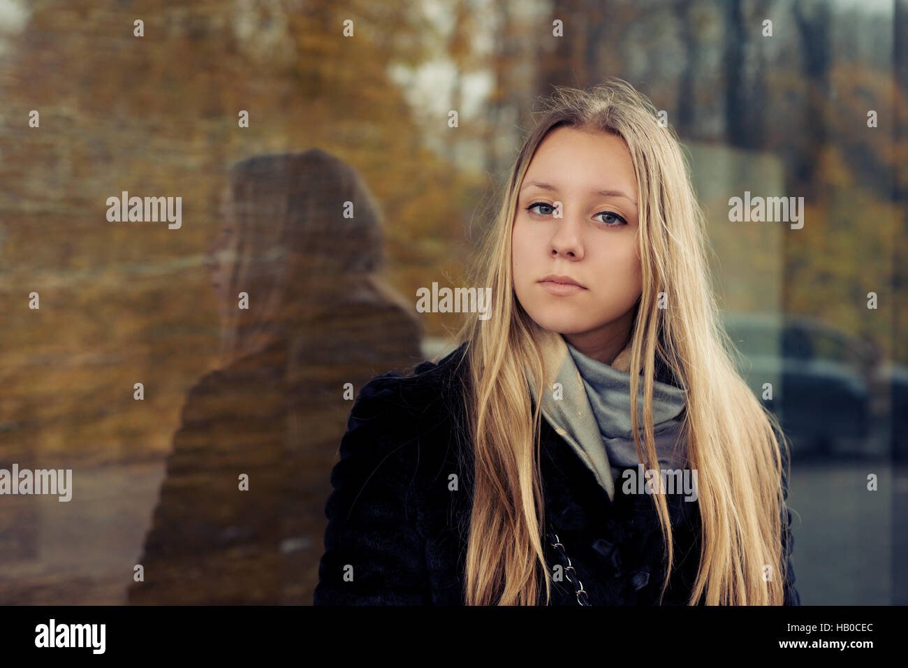 Portrait of a teen girl with long hair in a coat Stock Photo - Alamy