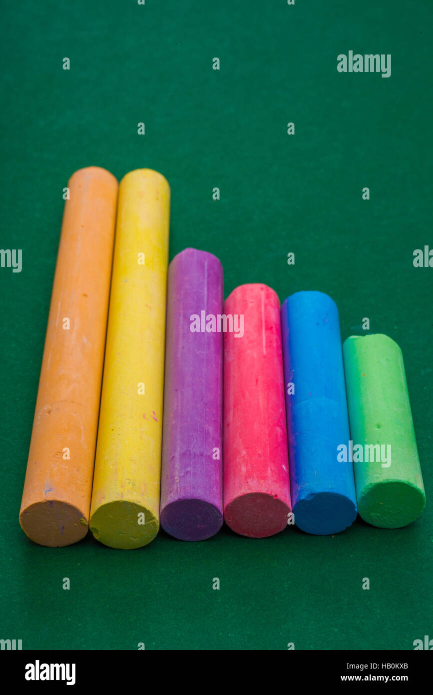 Six pieces of Chalk on Green Stock Photo