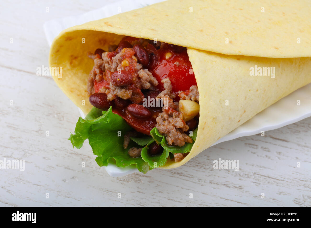 Burrito with beef, salad, beans and sauce Stock Photo Alamy