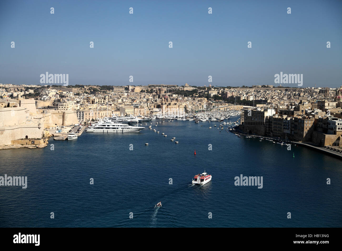 Landscape view of ferry traveling between Valletta and Sengela Three Cities Stock Photo