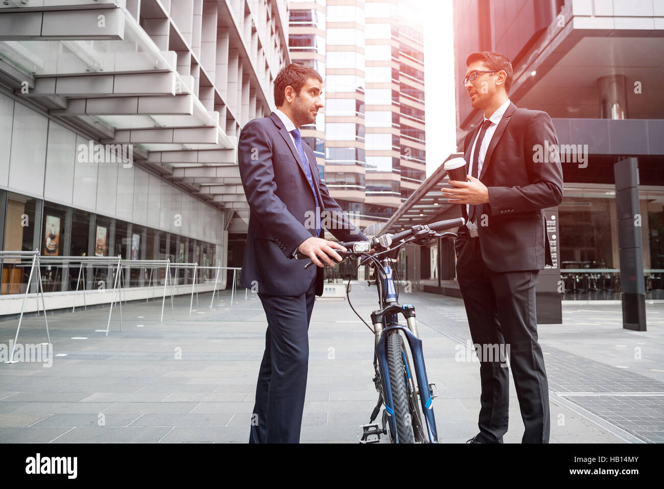 Two businessmen having walk Stock Photo - Alamy