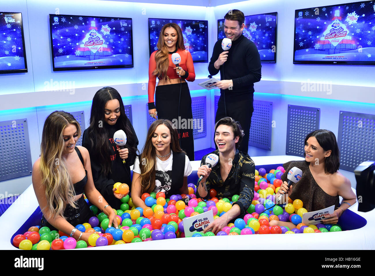 Little Mix are interviewed by the Capital Breakfast presenters Dave Berry, Lilah Parsons and George Shelley backstage during Capital's Jingle Bell Ball with Coca-Cola at London's O2 arena. Stock Photo