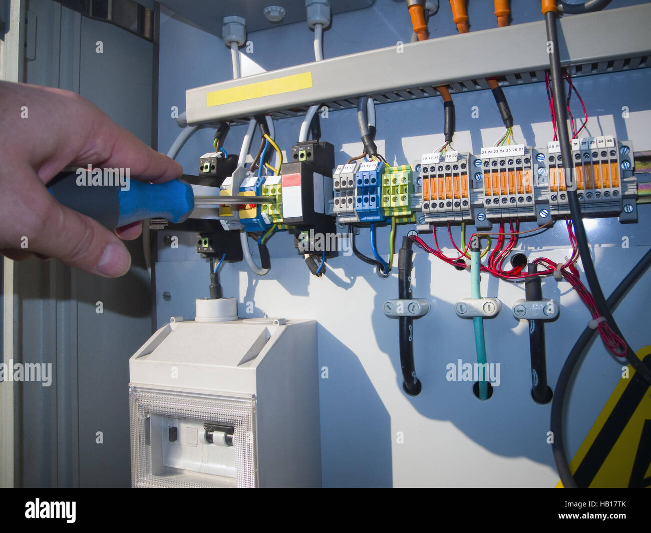hand with screwdriver for electonic units Stock Photo