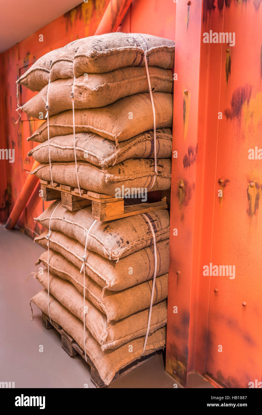Industrial image of two pallets with goods in burlap sacks, piled upon