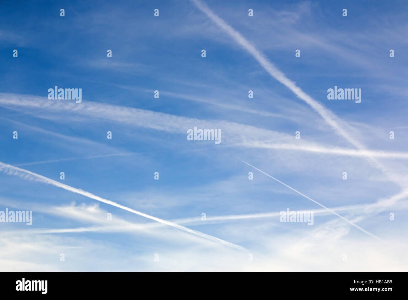 Sky with contrails and clouds, for use as background, copy or text. Stock Photo