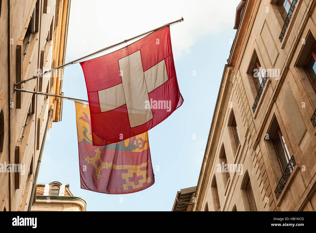 Geneva city, Switzerland. Swiss National and City flags mounted on house wall Stock Photo