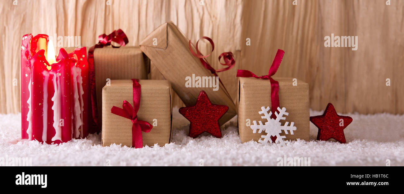 Christmas gifts and red Advent candle. Stock Photo