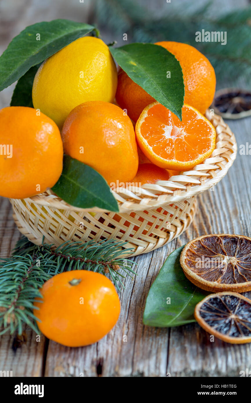 Basket with citrus and spruce branches. Stock Photo