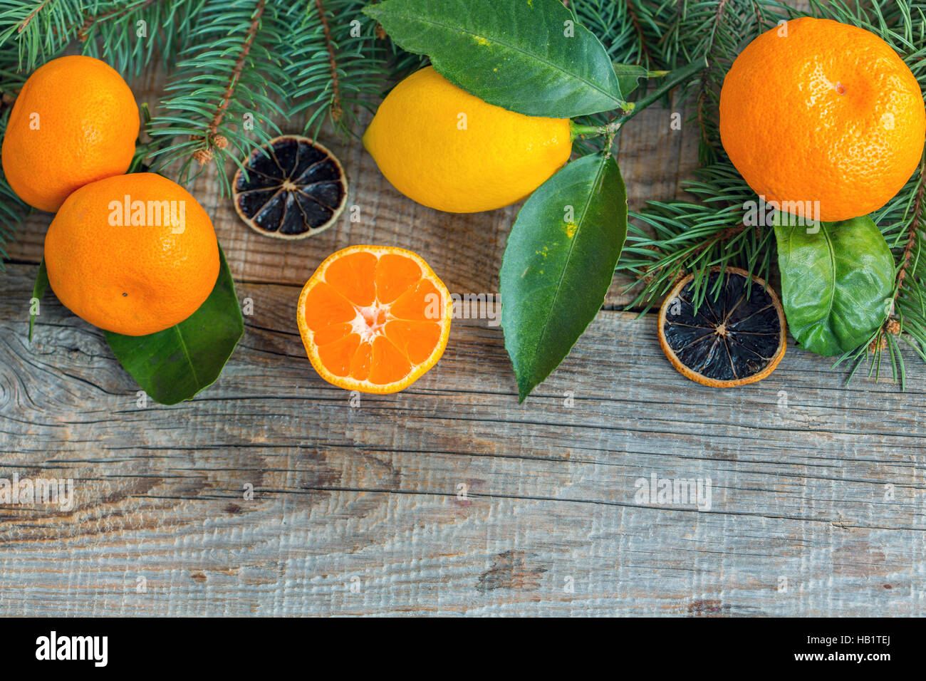 Tangerines, lemons and spruce branches. Stock Photo