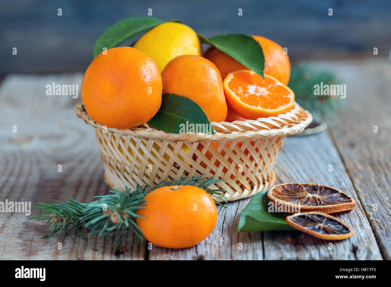 Basket with citrus and spruce branches. Stock Photo