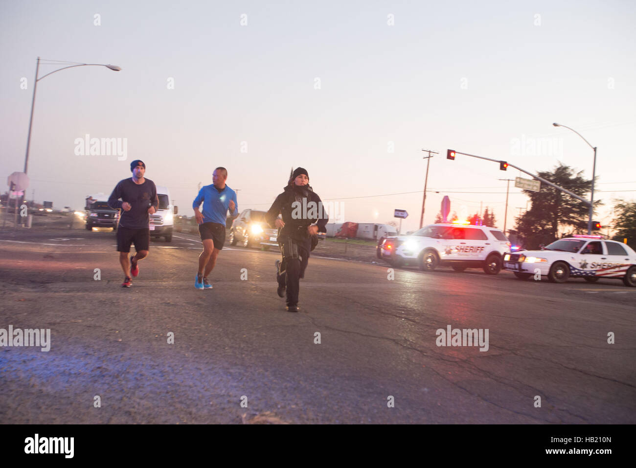 Turlock, CA, USA. 3rd Dec, 2016. Stanislaus County Sheriff along with Turlock Police Department escorted and blocked the roads for Los Angeles Police Officer Kristina Tudor as she runs down Golden State Blvd. south of Turlock California Saturday Saturday Dec. 3rd 2016 evening on her and Officer Joe Cirrito 420 mile run to Sacramento California from Los Angeles. The run is to raise awareness, funds and to honor the officers killed in the line of duty. Along with the families of officers killed in the line of duty. © Marty Bicek/ZUMA Wire/Alamy Live News Stock Photo