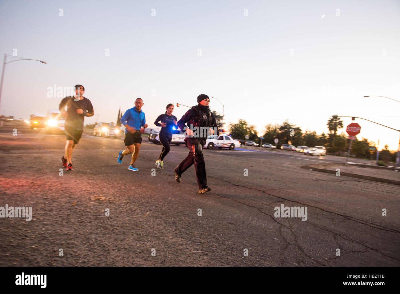 Turlock, CA, USA. 3rd Dec, 2016. Stanislaus County Sheriff along with Turlock Police Department escorted and blocked the roads for Los Angeles Police Officer Kristina Tudor as she runs down Golden State Blvd. south of Turlock California Saturday Saturday Dec. 3rd 2016 evening on her and Officer Joe Cirrito 420 mile run to Sacramento California from Los Angeles. The run is to raise awareness, funds and to honor the officers killed in the line of duty. Along with the families of officers killed in the line of duty. © Marty Bicek/ZUMA Wire/Alamy Live News Stock Photo