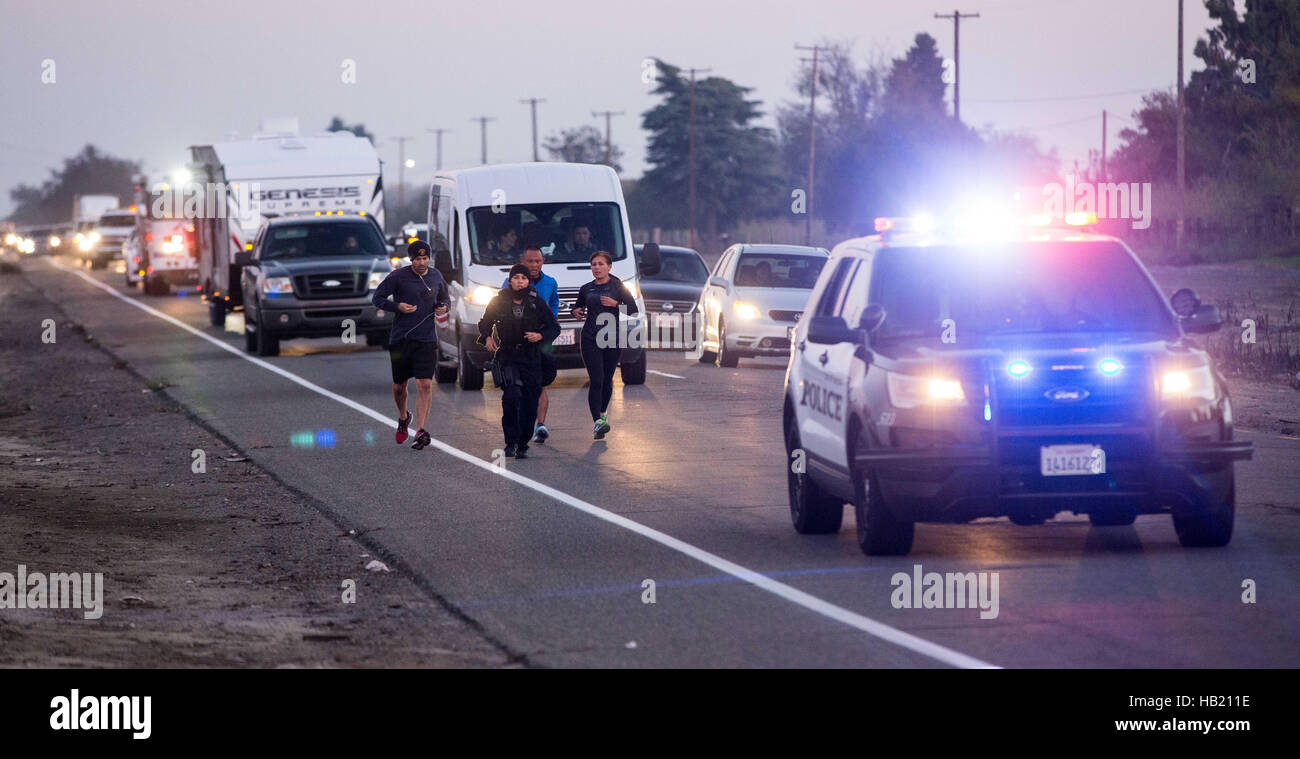 Turlock, CA, USA. 3rd Dec, 2016. Turlock Police Department escorted Los Angeles Police Officer Kristina Tudor as she runs down Golden State Blvd. south of Turlock California Saturday Dec. 3rd 2016 evening on her and Officer Joe Cirrito 420 mile run to Sacramento California from Los Angeles. The run is to raise awareness, funds and to honor the officers killed in the line of duty. Along with the families of officers killed in the line of duty. © Marty Bicek/ZUMA Wire/Alamy Live News Stock Photo