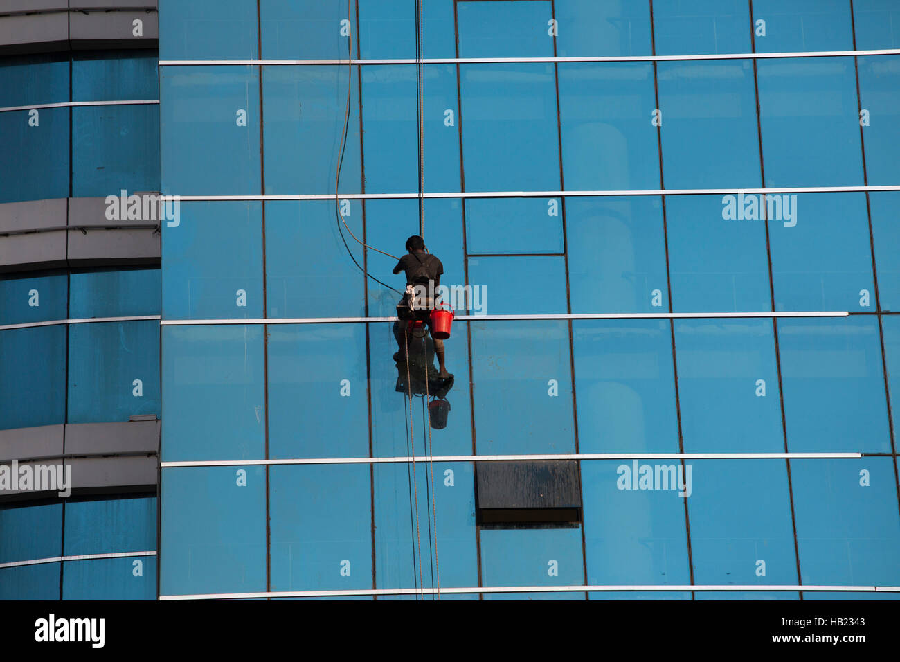 Dhaka, Bangladesh. 3rd Dec, 2016.  A labor clean the glass-wall of a high-rise building in Dhaka, Bangladesh on December 03, 2016. He is working a risky job and didn't use proper safety. Dhaka is the center of economic, cultural and political life in Bangladesh. Credit:  zakir hossain chowdhury zakir/Alamy Live News Stock Photo