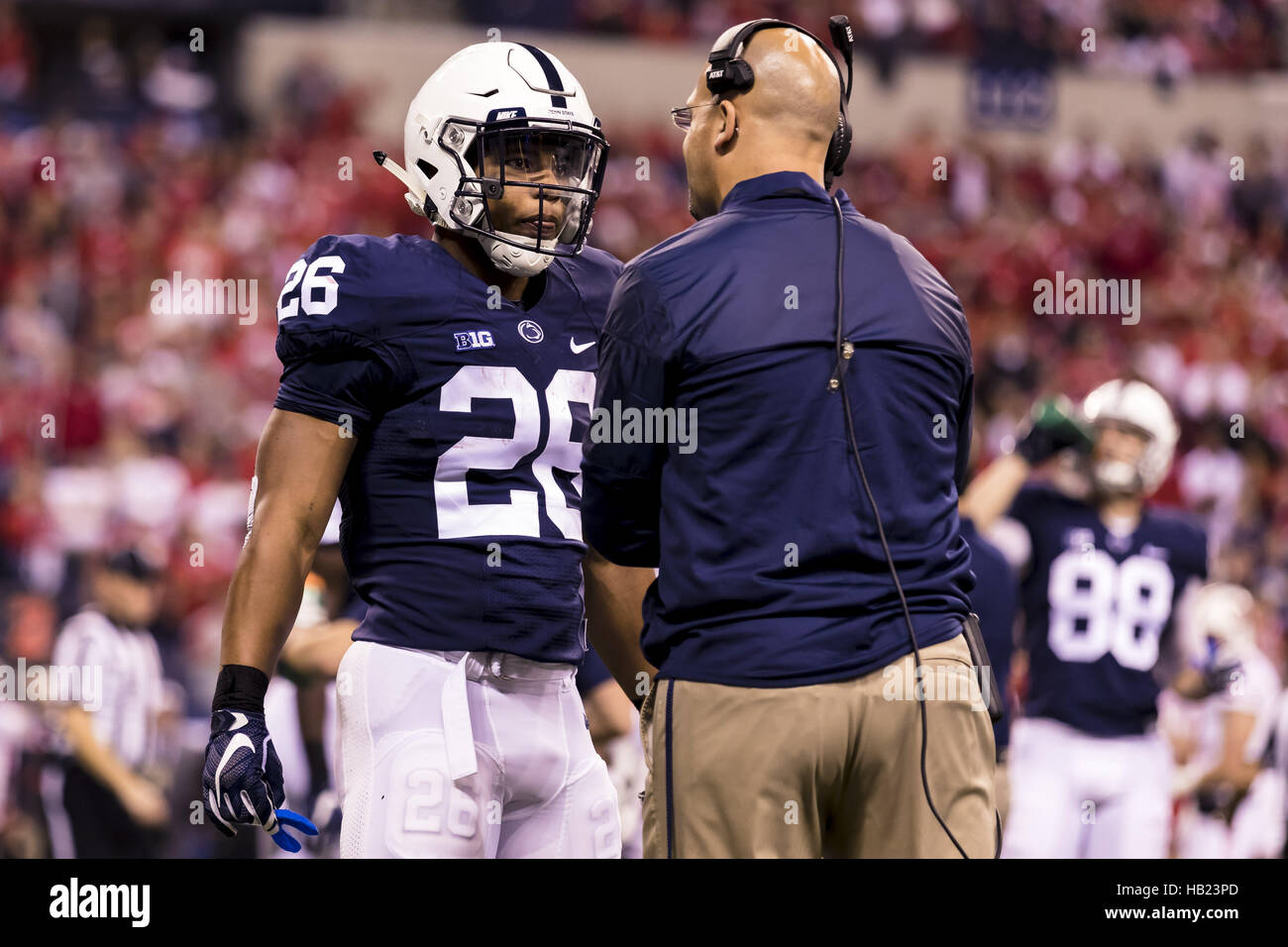 December 3, 2016 - Indianapolis, Indiana, U.S - December 3, 2016 - Indianapolis, Indiana - Penn State Nittany Lions head coach James Franklin talks to Penn State Nittany Lions running back Saquon Barkley (26) in the first half during the Big Ten Championship game between Penn State Nittany Lions and Wisconsin Badgers at Lucas Oil Stadium. (Credit Image: © Scott Taetsch via ZUMA Wire) Stock Photo