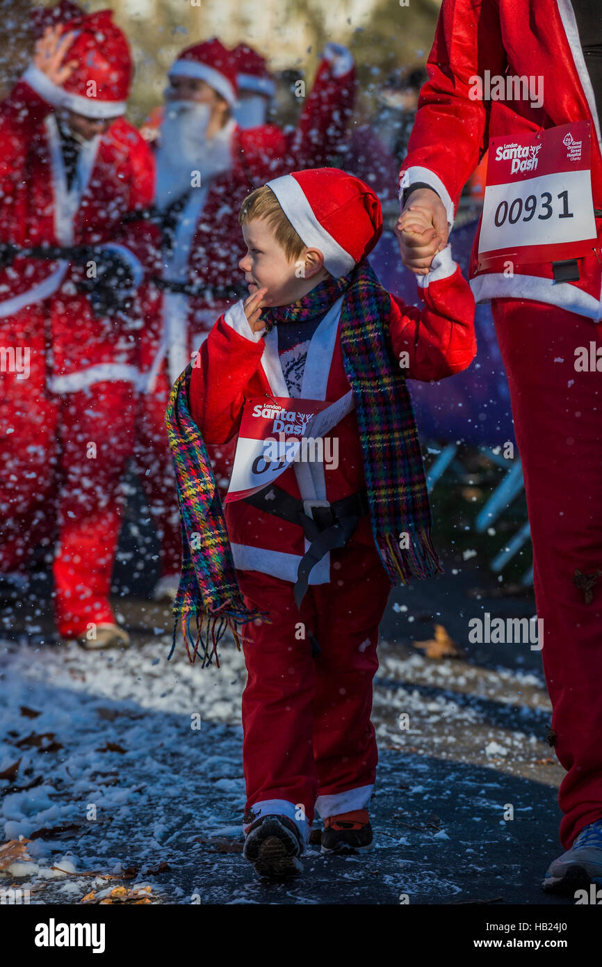 London, UK. 4th Dec, 2016. The finish brings relief and a shower of 'snow' - Thosuands of runners, of all ages, in santa suits and other Christmas costumes runaround Clapham Common for Great Ormond Street Hospital and for fun. Credit:  Guy Bell/Alamy Live News Stock Photo
