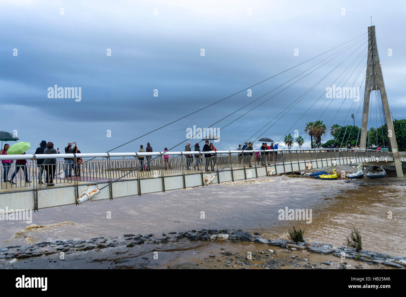 Fuengirola, Andalusia, Spain. 4th december, People at bridge over Fuengirola river which becomes Flash flood leaving debris behind at river mouth. 2016. Credit:  Perry van Munster/ Alamy Live News Stock Photo