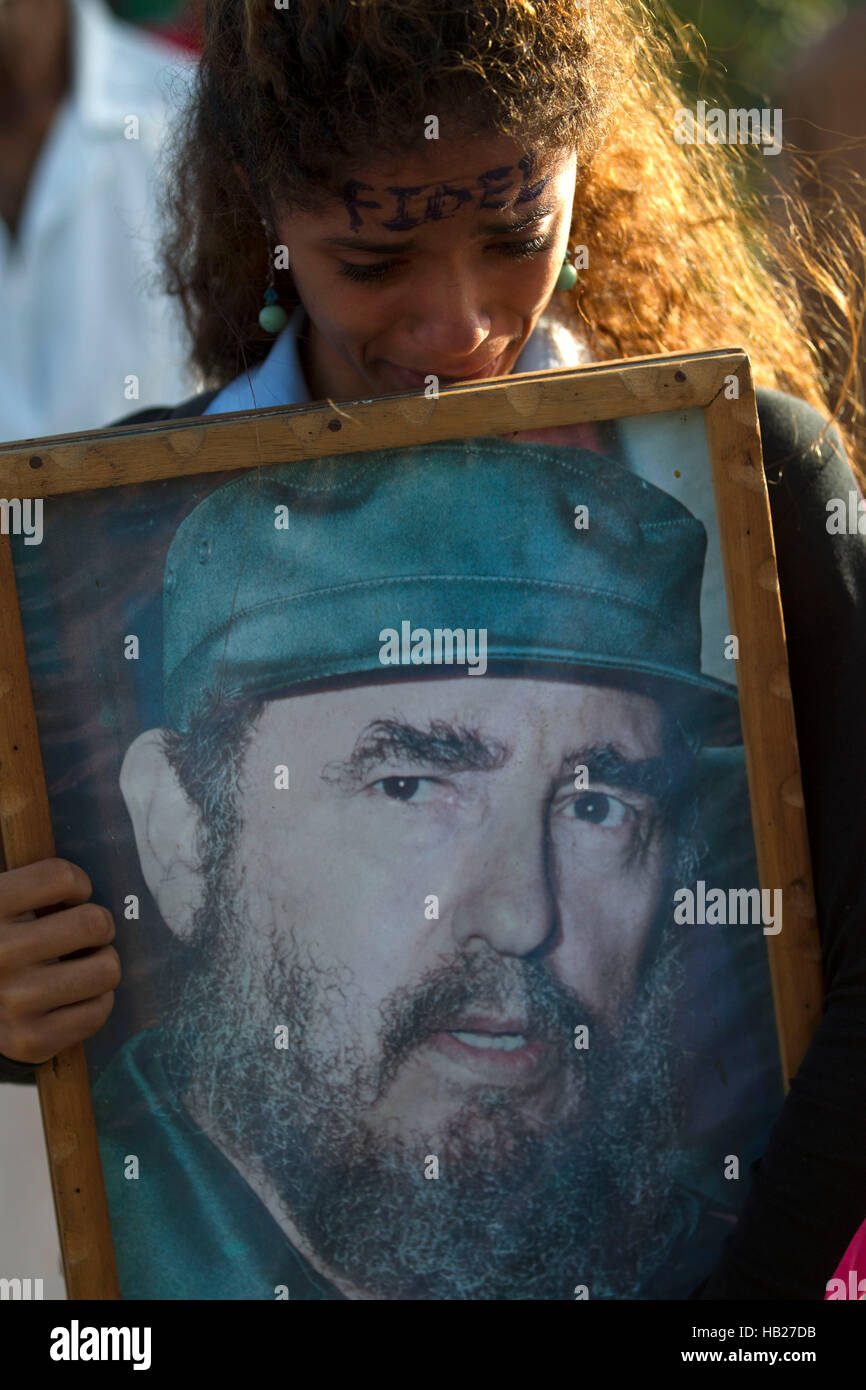 Santiago De Cuba, Cuba. 4th Dec, 2016. A woman holds a poster of Cuban revolutionary leader Fidel Castro during the passage of his funeral cortege to the Santa Ifigenia Cemetery in the city of Santiago de Cuba, Cuba, on Dec. 4, 2016. The remains of the Cuban revolutionary leader and former President Fidel Castro were buried Sunday morning at the Santa Ifigenia cemetery in Santiago de Cuba. Credit:  David de la Paz/Xinhua/Alamy Live News Stock Photo