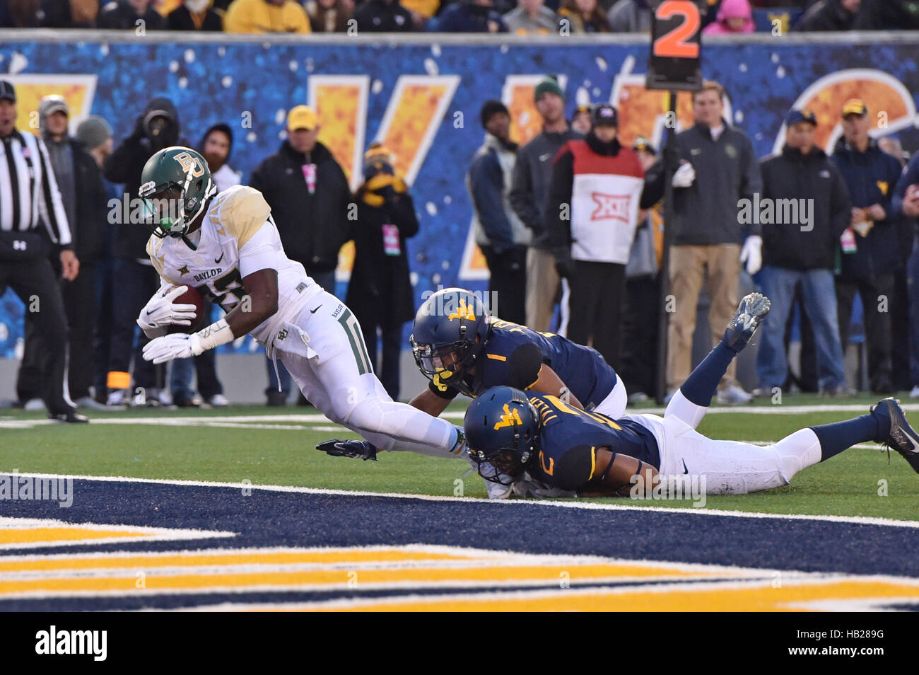 Morgantown, West Virginia, USA. 3rd Dec, 2016. Baylor Bears running back TERENCE WILLIAMS (22) falls into the end zone for a score as he is tackled by West Virginia Mountaineers cornerback ANTONIO CRAWFORD #1 and safety JEREMY TYLER #2 and during a game played at Mountaineer Field in Morgantown, WV. WVU beat Baylor 24-21. © Ken Inness/ZUMA Wire/Alamy Live News Stock Photo