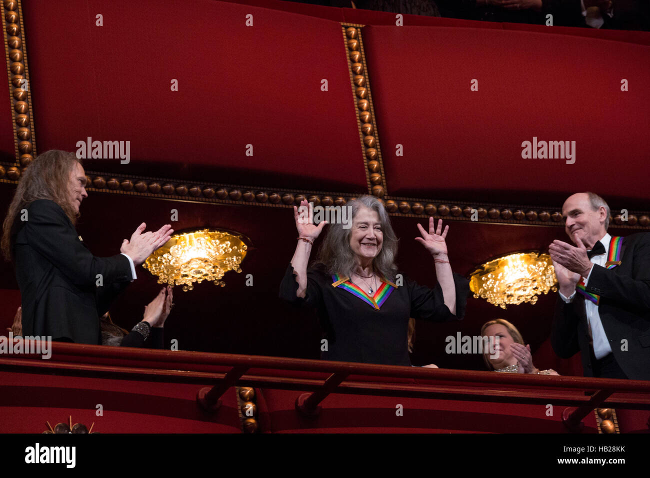 Washington DC, USA. 4th Dec, 2016. 2016 Kennedy Center Honoree pianist Martha Argerich waves at the beginning of the Kennedy Center Honors, at the Kennedy Center, December 4, 2016, Washington, DC. The 2016 honorees are: Argentine pianist Martha Argerich; rock band the Eagles; screen and stage actor Al Pacino; gospel and blues singer Mavis Staples; and musician James Taylor. Credit: Aude Guerrucci/Pool via CNP /MediaPunch Credit:  MediaPunch Inc/Alamy Live News Stock Photo