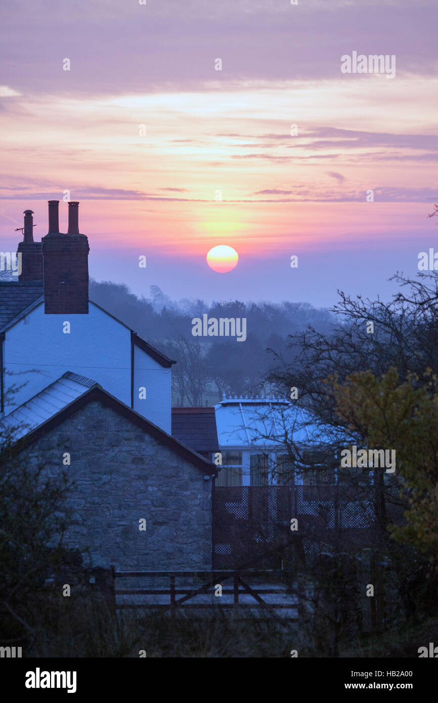 Sunrise over a misty frozen landscape in the village of MoelyCrio
